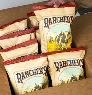 Box of Rancher's potato chips bags with a hand holding one bag.